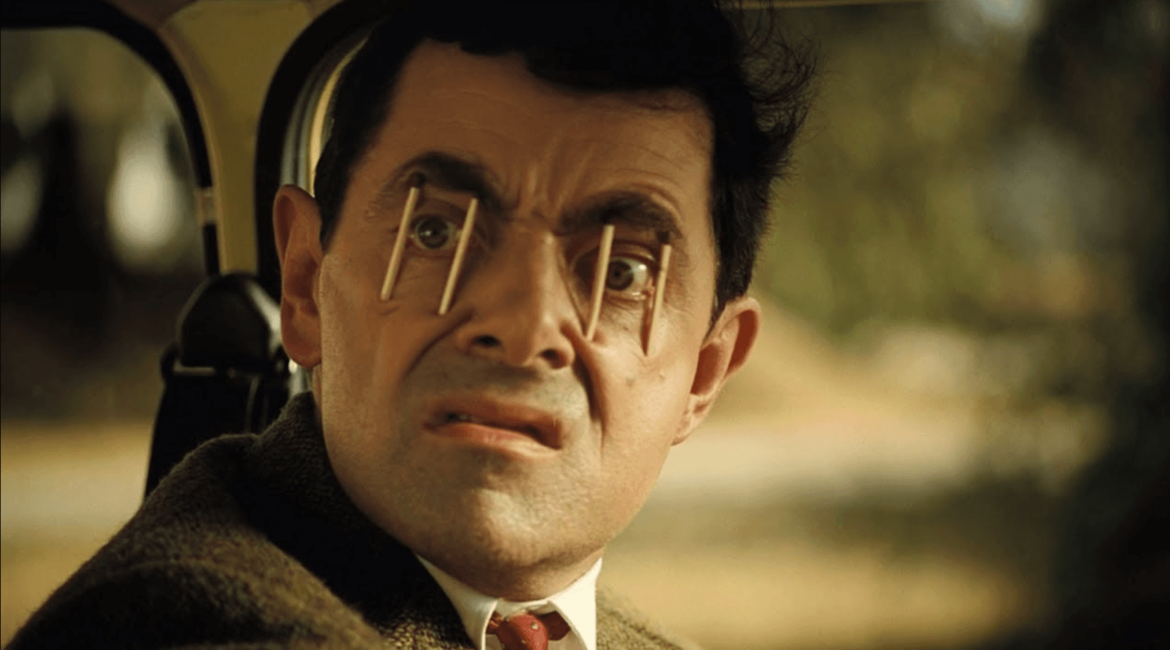 Mr. Bean trying not to fall asleep while driving